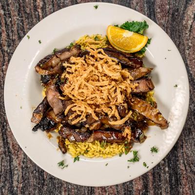 Steak tips, with rice and crispy onions.