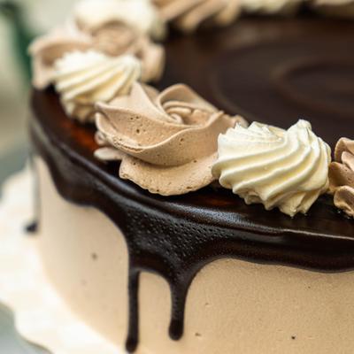 Chocolate drip cake finished with beautiful swirls of cocoa and vanilla buttercream.