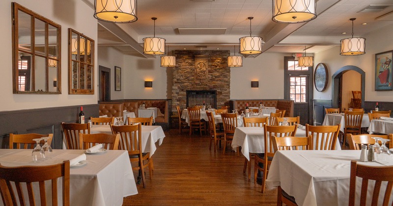 Elegant and spacious dining area with dining tables set for guests