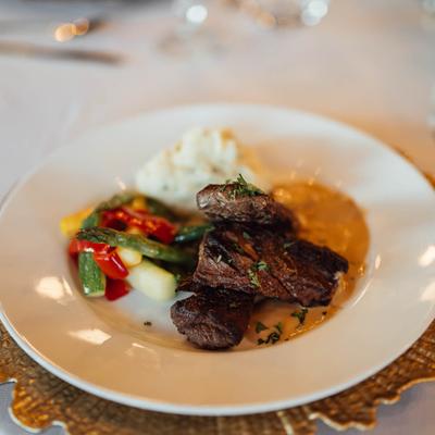 Beef with veggies and mashed potatoes.