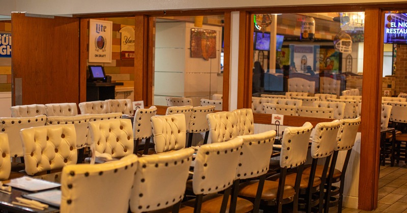 Interior, tables and cushioned chairs in dining area