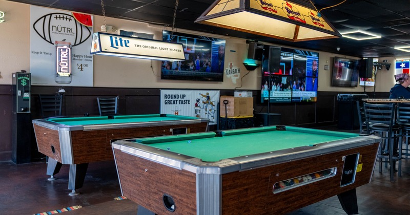 Interior, entertainment area, billiards tables, TV sets on the wall