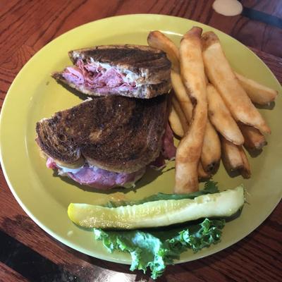 Reuben on grilled marble rye, with pickle and fries