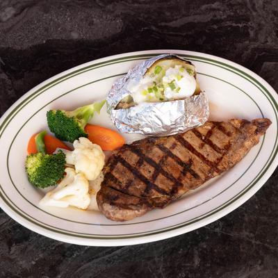New York Steak served with veggies and baked potato.