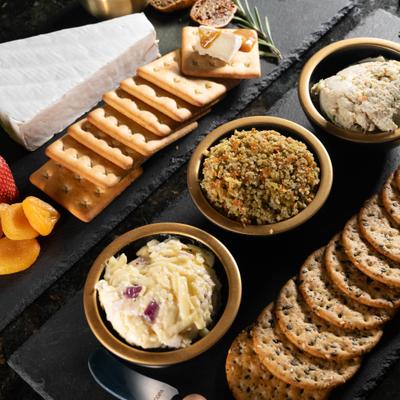 Crackers, spread, brie cheese, and fruit.