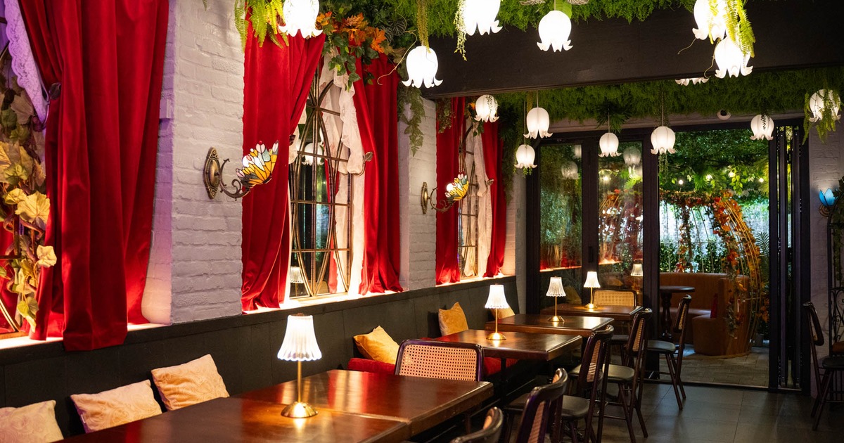 Interior, dining area, banquette bench with wooden top tables and chairs, wall curtains