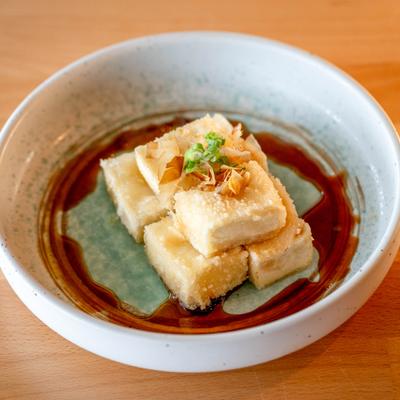 Agedashi Tofu cubes served with soya sauce.