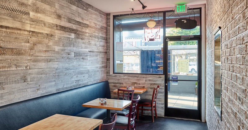 Interior, tables and chairs ready for guests with entrance in the back