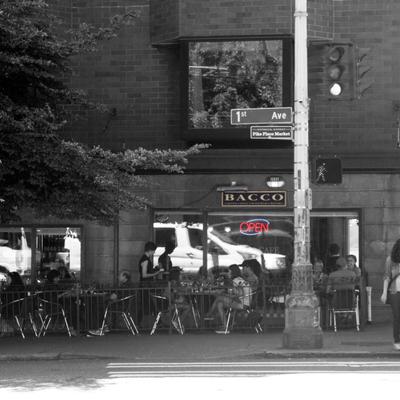 Outdoor seating area with signage and an 'Open' sign.