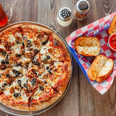 Whole Pizza served alongside Garlic Bread Cheese Sticks, top view.