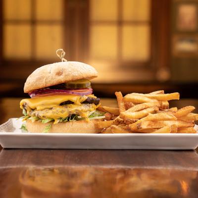 Cheeseburger served with beer