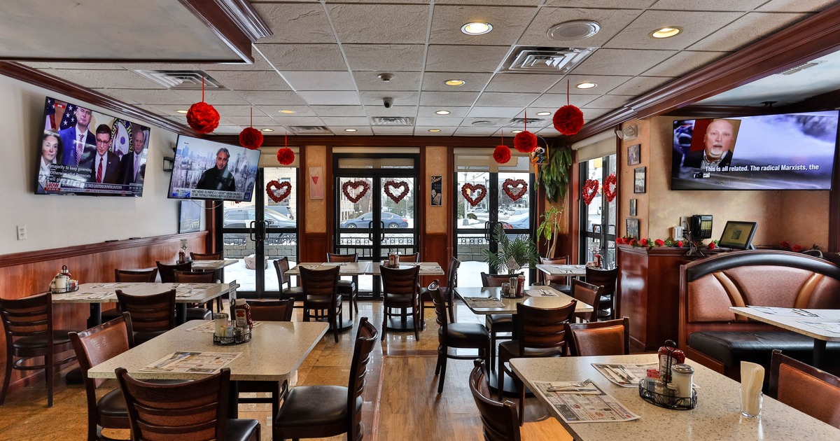 Dining area, tables ready for guests, TVs on the walls