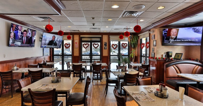 Dining area, tables ready for guests, TVs on the walls