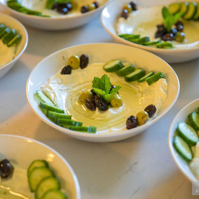 Plates of white sauce and cucumbers