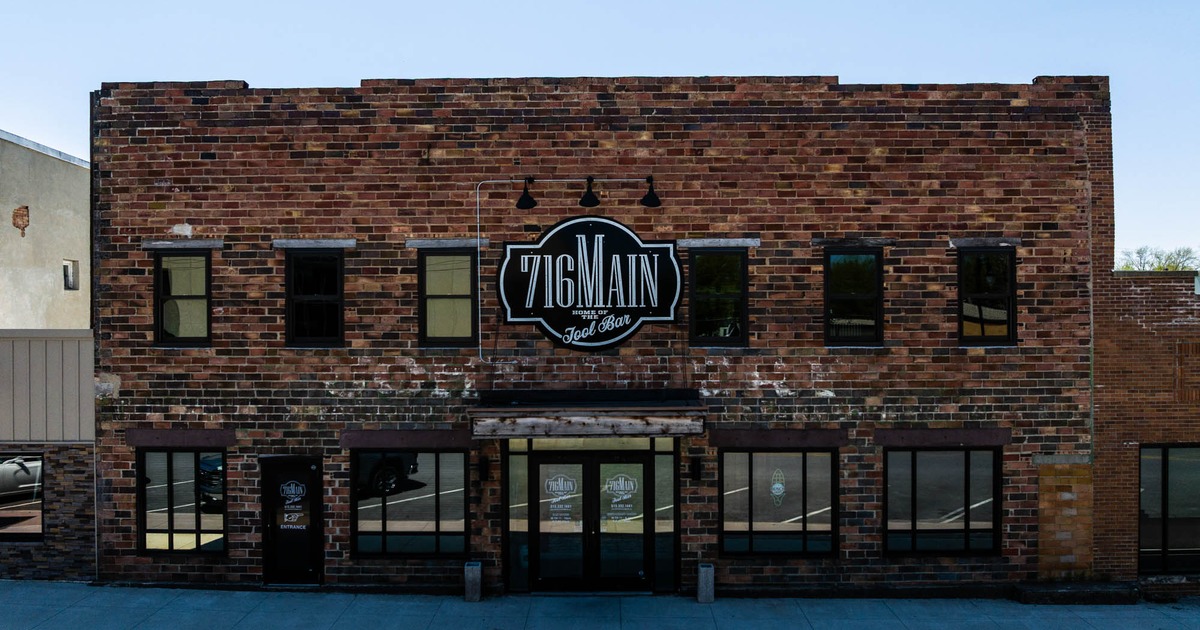 Exterior of a multi-story brick building with the 716 Main sign and multiple windows