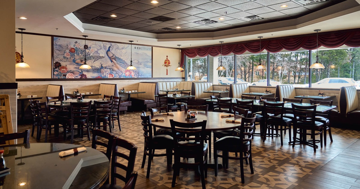 Interior, open space dining area, wooden tables with chairs, seating booths with tables