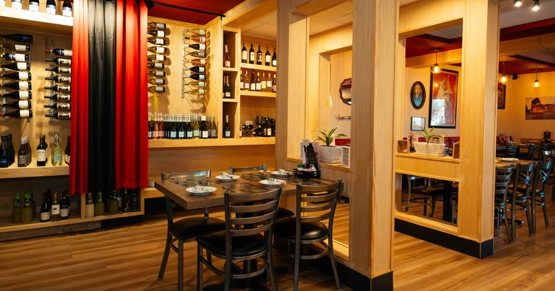 Interior, dining area, table for four, large over-the-wall wooden wine shelves
