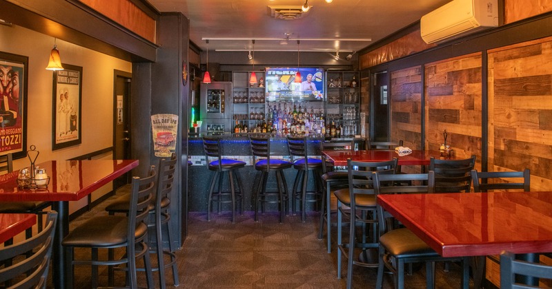 Seating tables with bar stools and a bar