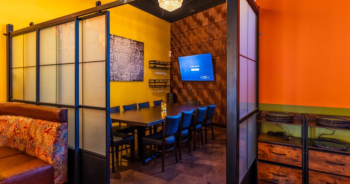 Interior, private space for 10 guests with a big TV on the wall