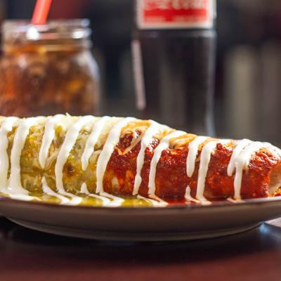 Burrito smothered in green and red salsas.