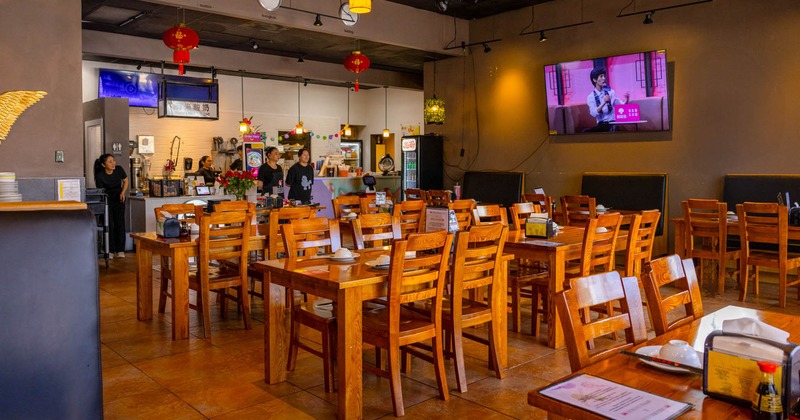 Interior, dining area, massive wooden tables with chairs,  serving station in the back