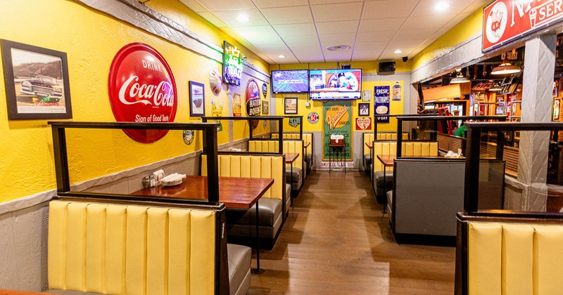 Interior of a retro-themed restaurant with yellow booths