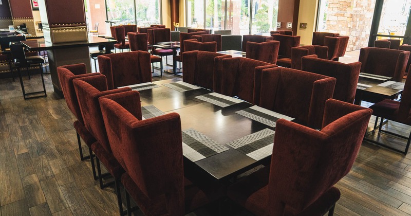A large table with comfortable chairs, ready for guests.