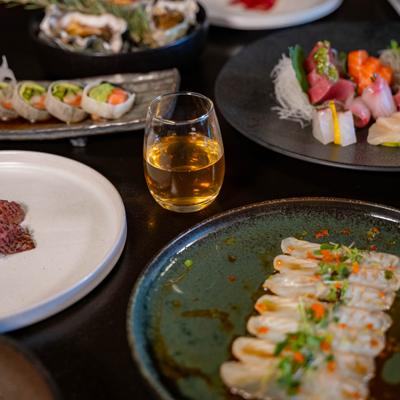 Assorted Japanese dishes served with a drink.