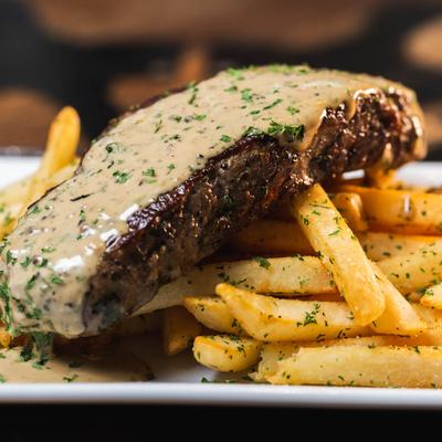 NY strip steak topped with creamy peppercorn sauce, side of fries
