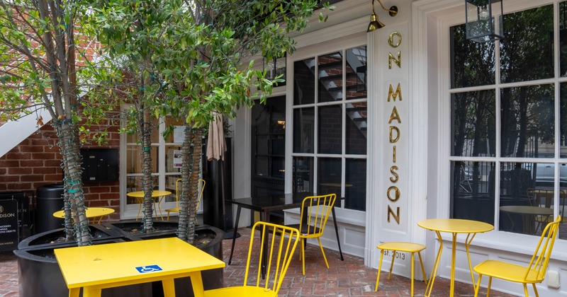 Outdoor seating area with yellow tables and chairs