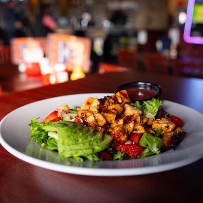 Chicken Strawberry Salad with a dressing on the side.