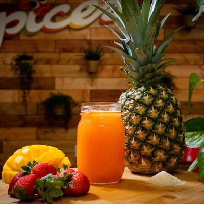 Strawberry Mango Smoothie arranged on the table with fresh pineapple, mango and strawberries