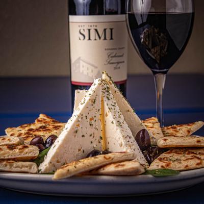 Feta, olives, pita and wine served