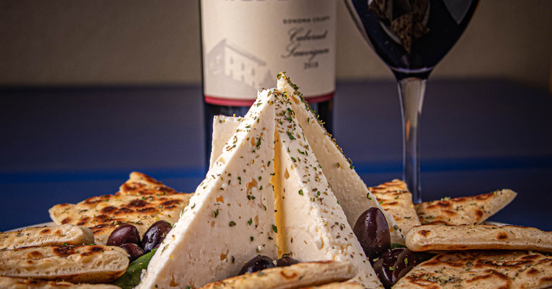 Feta, olives, pita and wine served