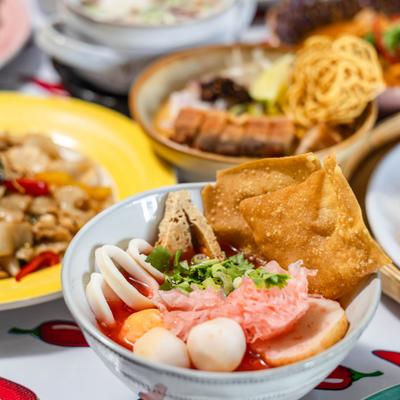 Thai pink noodle soup with fermented tofu broth, seafood, and crispy wontons.