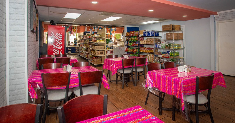 Interior, tables and chairs, various merchandise items on shelves in the back