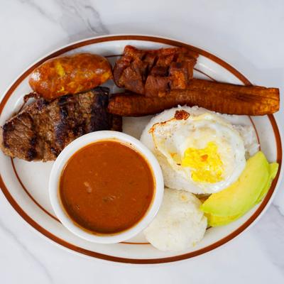 Breakfast plate with assorted meats and sides.