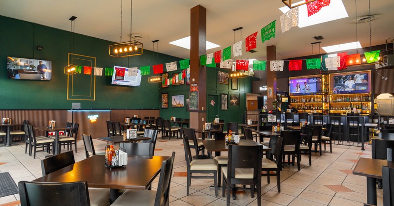 Interior, open space dining area, wooden top tables for two and four, ready for guests