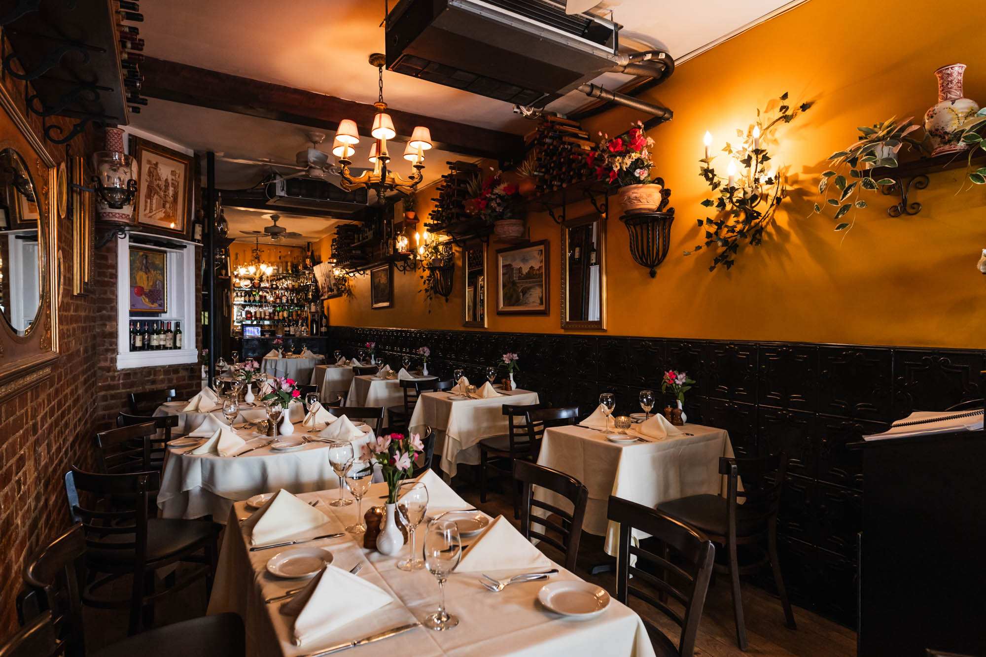 Interior, set tables with folded napkins and vases with fresh cut flowers