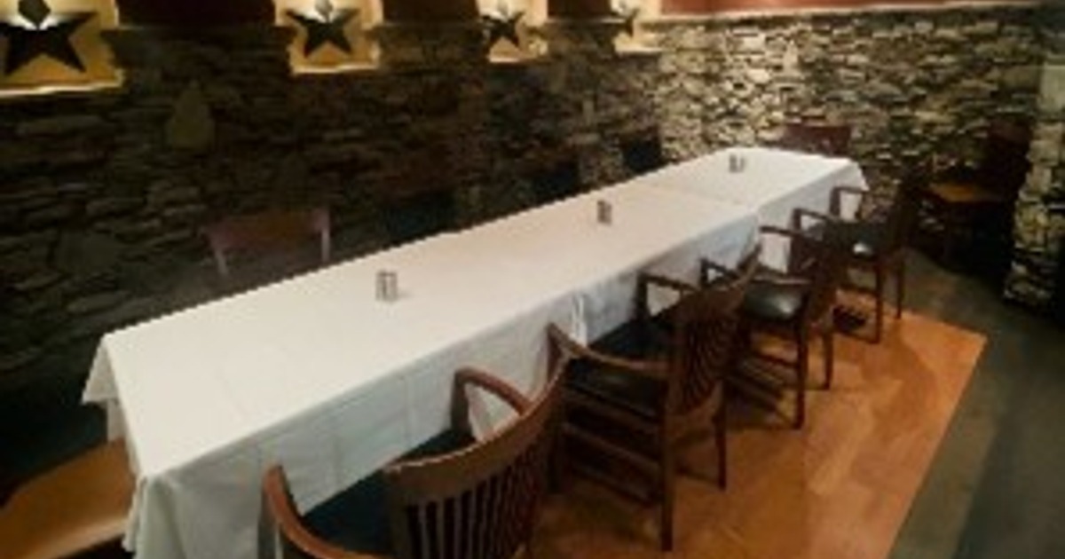 Long dining table with white tablecloth