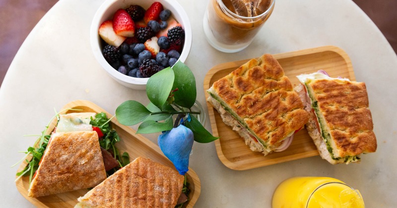 Sandwiches, fruit bowl, and iced coffee