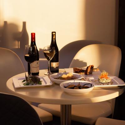 Assorted food, red, and white wine on the table.