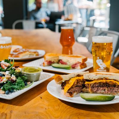Different food dishes and beers served on the table