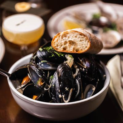 Mussels in white wine creamy mustard sauce with garlic buttered baguette.