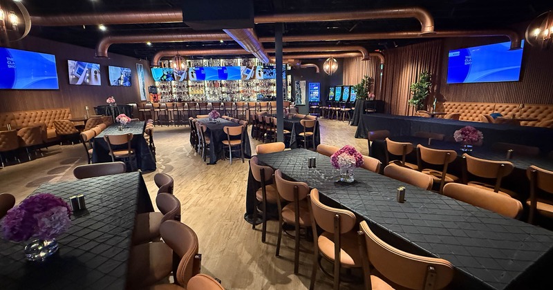 Dining booths and tables, large wall TV screens