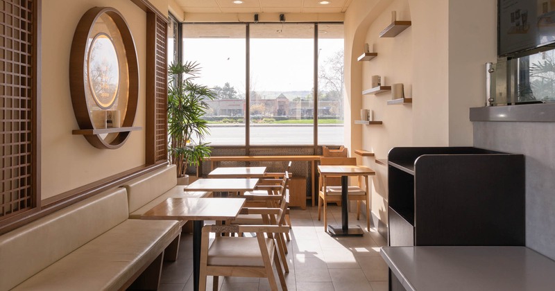 Interior, dining area, banquette bench with tables and chairs, waiter serving station