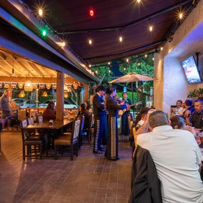 Live mariachi band performing on an outdoor patio.