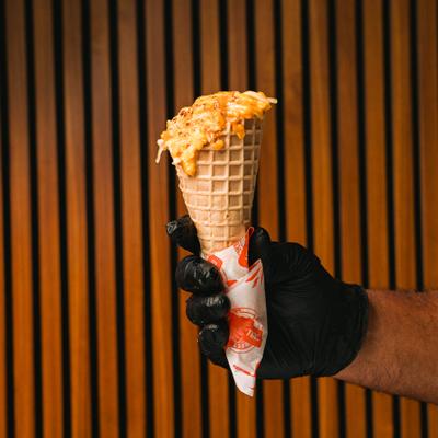 Hand holding a Waffle Cone Nachos.