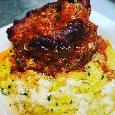 Braised veal shank on rice.