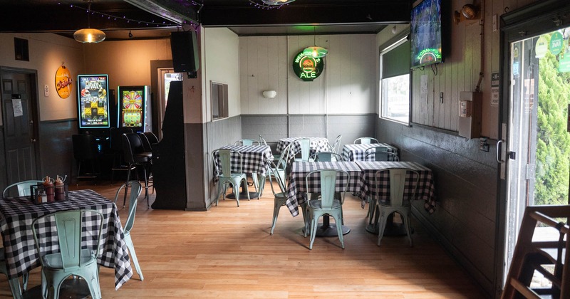 Interior, tables with checkered tablecloths and chairs